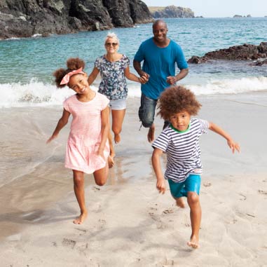 Family running on beach