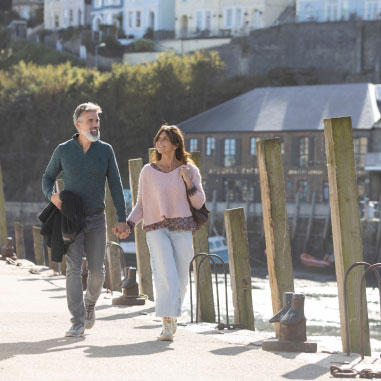 couple walking along a pier