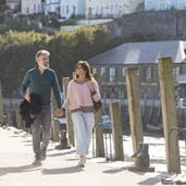 couple walking along a pier
