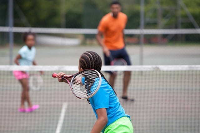 family playing tennis