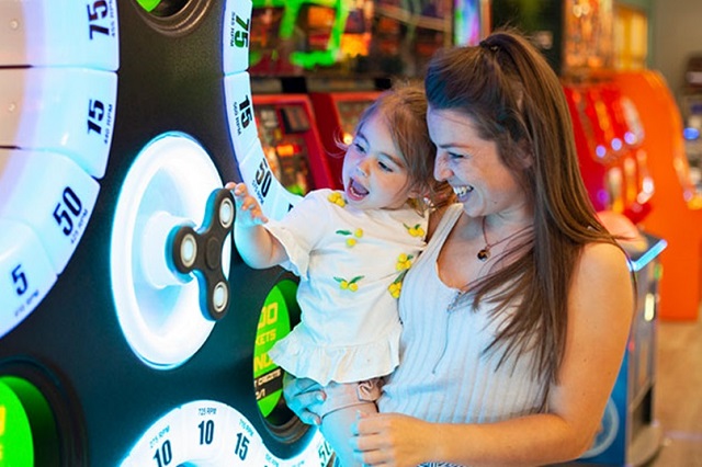 mother and daughter playing on amusement arcades