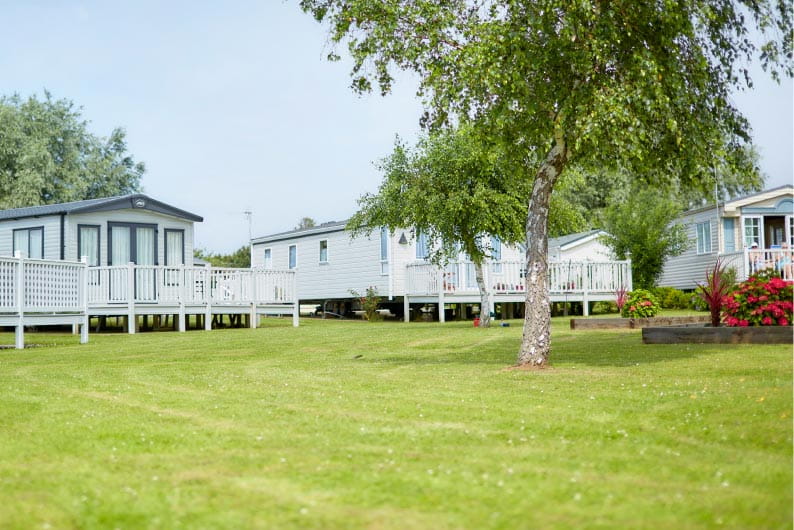 Park Dean caravans surrounded by trees and green fields