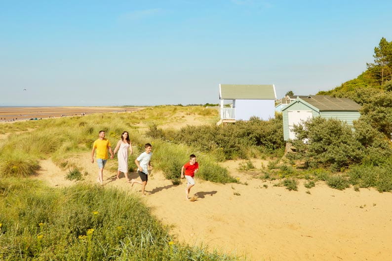 a family walking across a beach