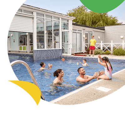 Family enjoying outdoor pool at Manor Park Holiday Park