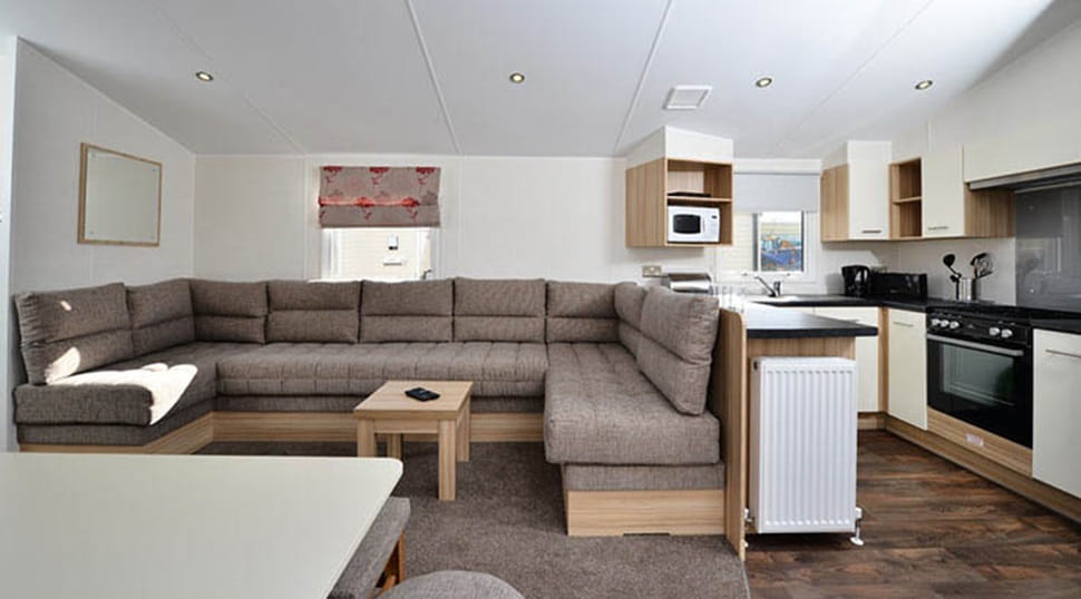 The living room and kitchen interior of a caravan