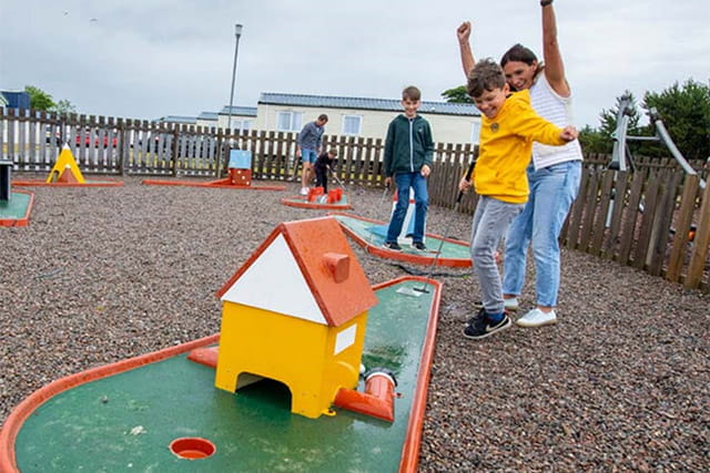 A family game of crazy golf at Nairn Lochloy Holiday Park