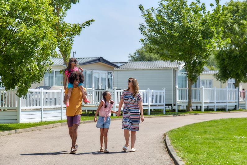 Family walking hand in hand through Parkdean Resorts