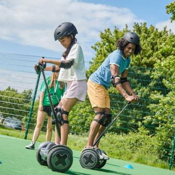Kids stood on a segway