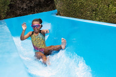 A child riding an outdoor water flume