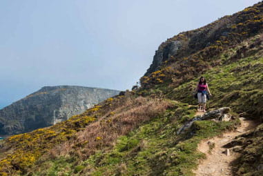 A hiker walking though the hills