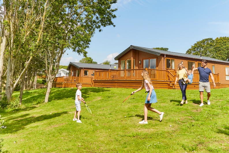 a family walking near a lodge