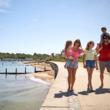 a family walking along the harbour