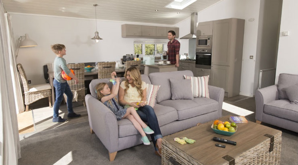 A family relaxing in their lodge living room and kitchen