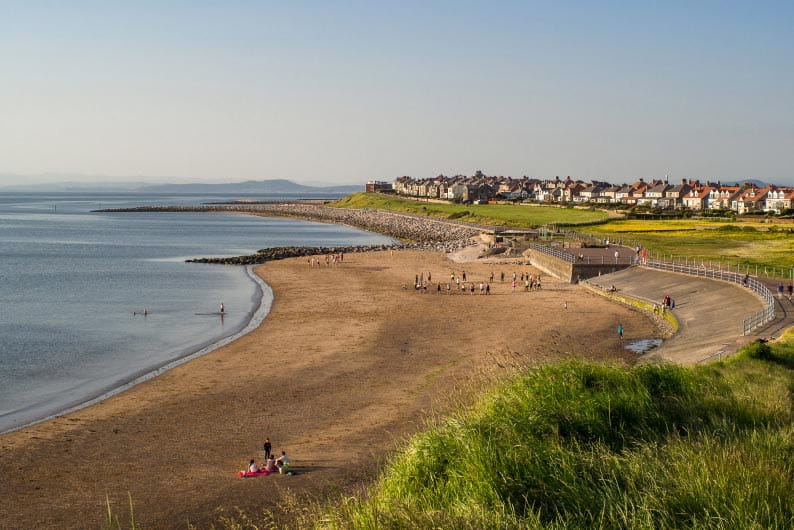 Sandy beach with village in the distance