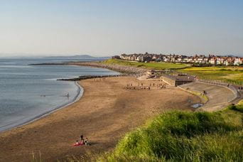 Sandy beach with village in the distance