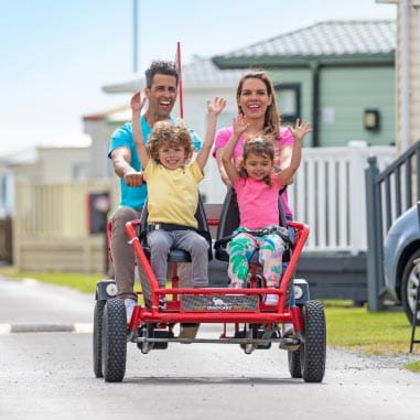 Family riding on a red family kart