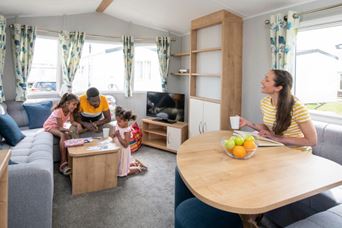 Family sat in caravan living room