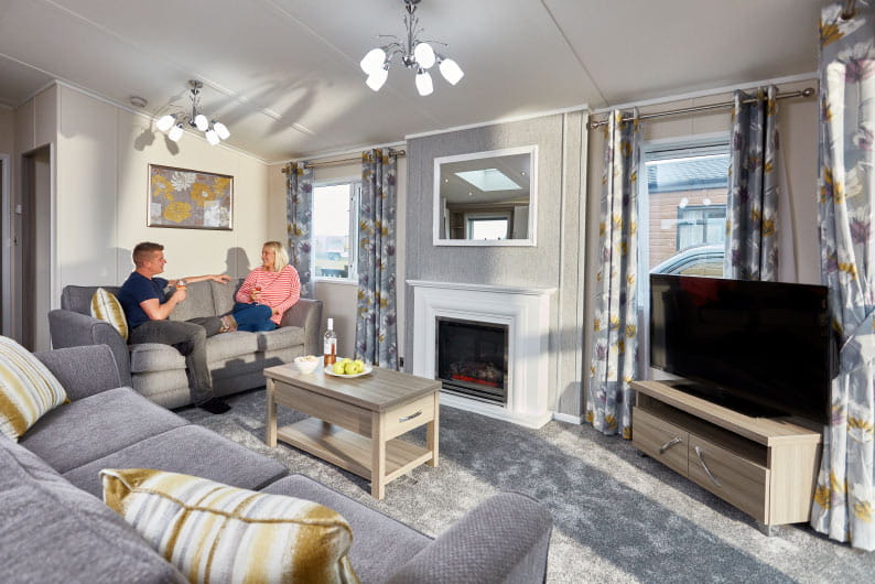 Couple sat on sofa watching TV