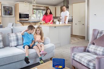 Kids sat on sofa with parents onlooking
