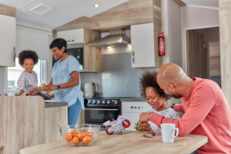Family sat in kitchen and living room