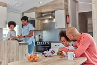 Family sat in kitchen and living room
