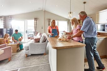 Adults stood around kitchen island