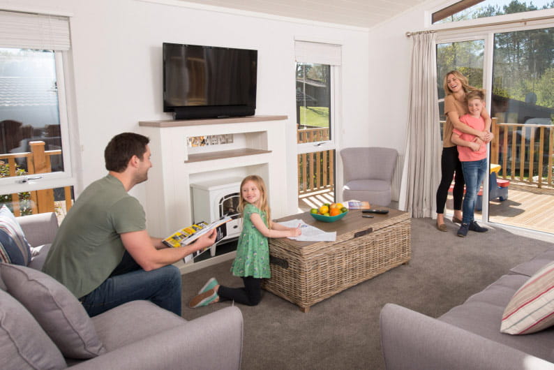 Dad sat on sofa watching children play board games