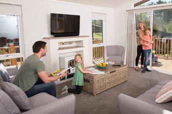 Dad sat on sofa watching children play board games