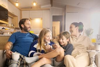 Family sat snuggled on sofa