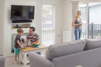Dad and son talking in the caravan living room
