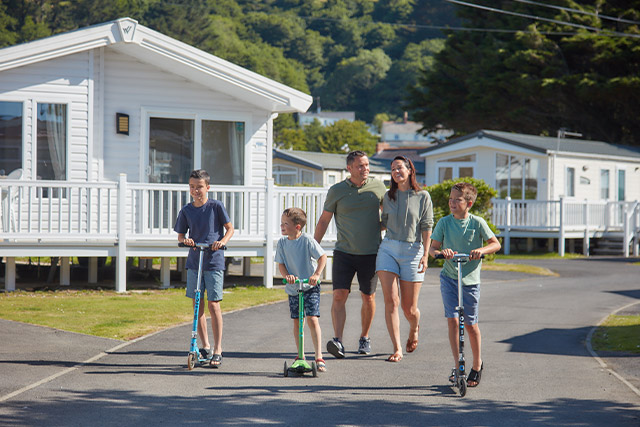 A family walking past holiday caravans at Pendine Sands Holiday Park