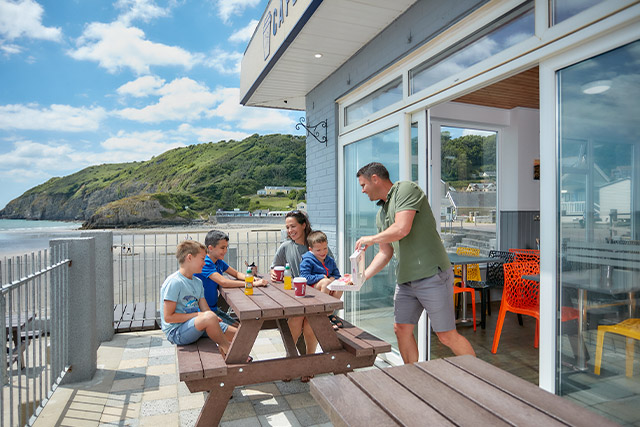 A enjoying drinks at the beach cafe at Pendine Sands Holiday Park