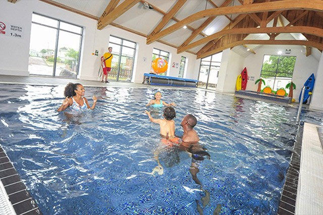 A family playing in the indoor swimming pool at Regent Bay Holiday Park