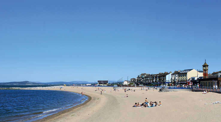 Morecambe Bay Beach and promenade on a sunny day