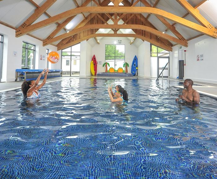 A family playing ball games in the indoor pool at Regent Bay Holiday Park