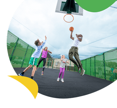 A family playing basketball on the multi-sports court at Regent Bay Holiday Park