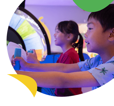 Two kids playing on the arcade games at Romney Sands Holiday Park