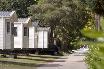 A row of caravans in a green park