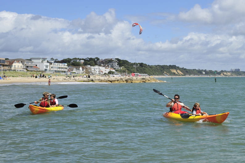 Kayaks in the sea on the Dorset coast