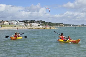 Kayaks in the sea on the Dorset coast
