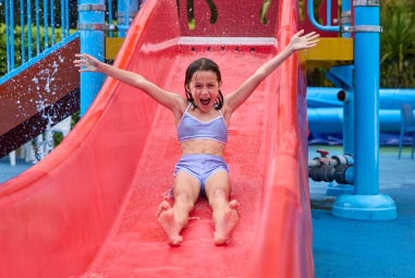 A child riding an outdoor water slide