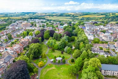 A small town surrounded by trees and greenery
