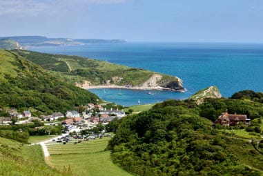 Green rolling countryside and the blue sea surrounding Lulworth