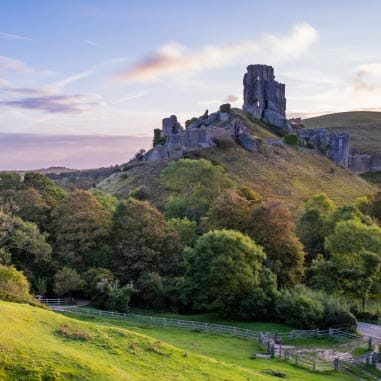 castle ruins on a hill surrounded by countryside