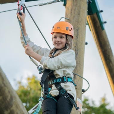 a child on a high ropes course