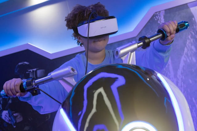 A boy on a virtual reality racing game at Sandford Holiday Park