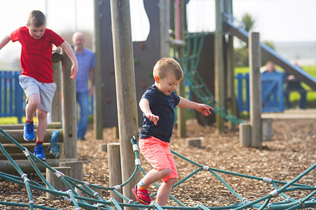 Two boys playing on the adventure playground