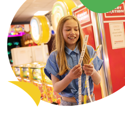 A girl with winning tickets in the amusement arcade at Sandy Bay Holiday Park