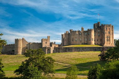an ancient castle surrounded by countryside