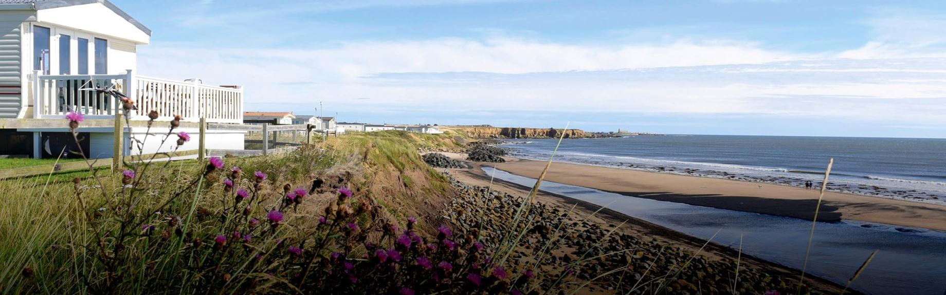 A holiday park at the edge of a sandy beach